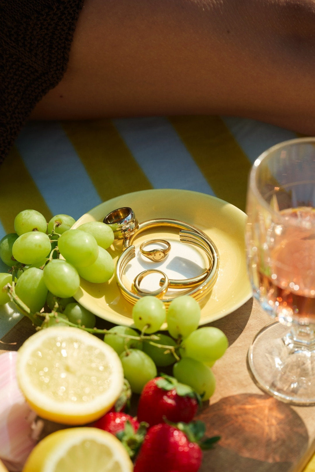 picnic in the grass with fruit and jewellery